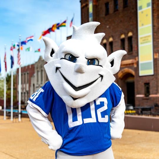 The Billiken posing for a photo on campus