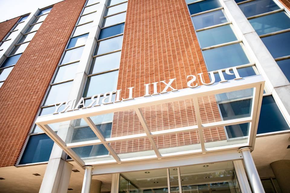 A view of an entrance to Pius Library looking up toward the top of the building.