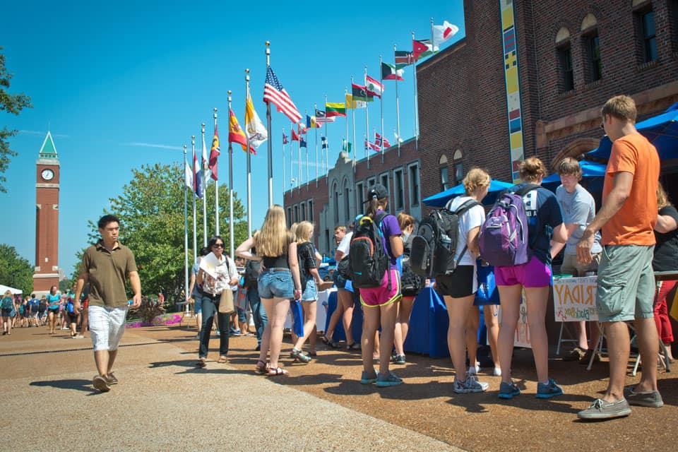 Students stand around informational tables on West Pine Mall.